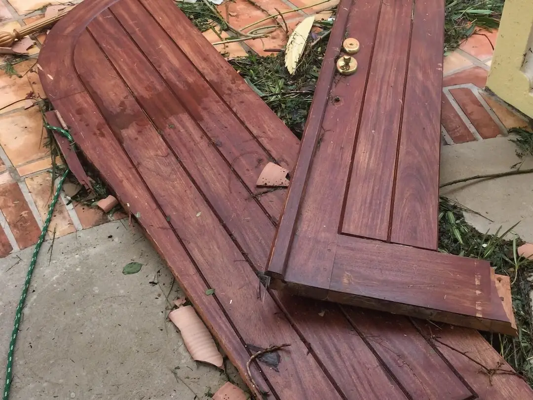 Hurricane Irma in BVI - Damege to Doors Brown wooden doors laying smashed on the ground
