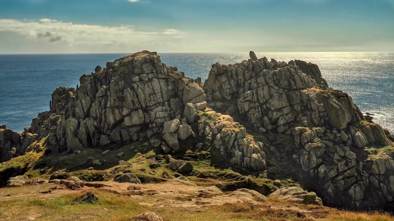 Logan Rock - Cornwall - England Two sets of rocks between a grassy headland the sea